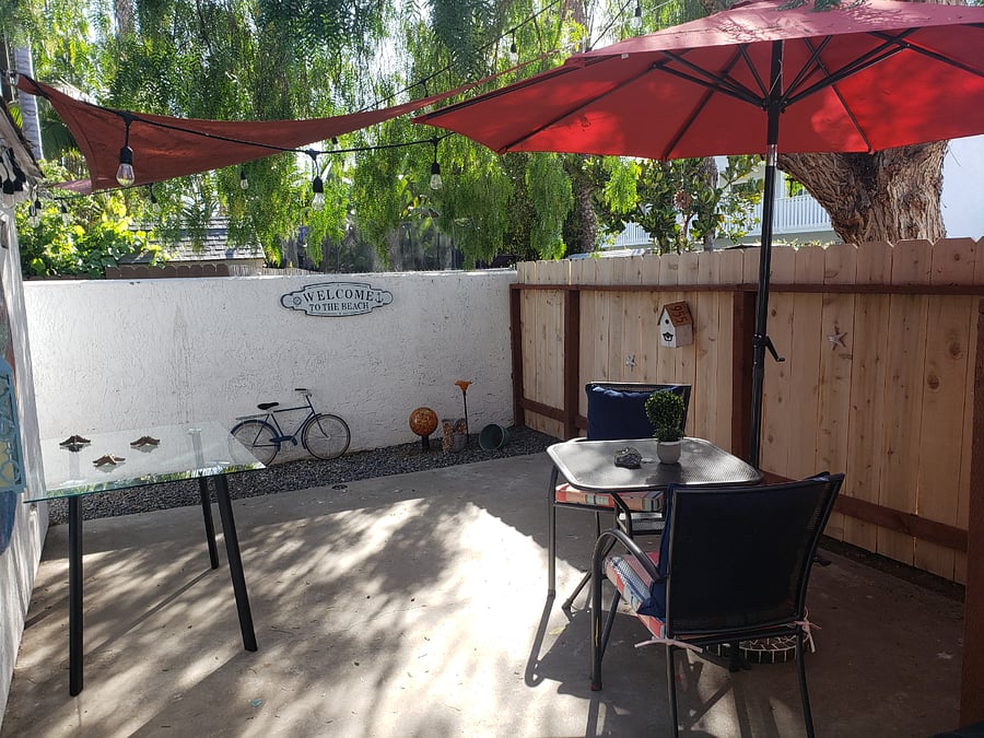 Private backyard oasis for dining, BBQ, fire table, and shower