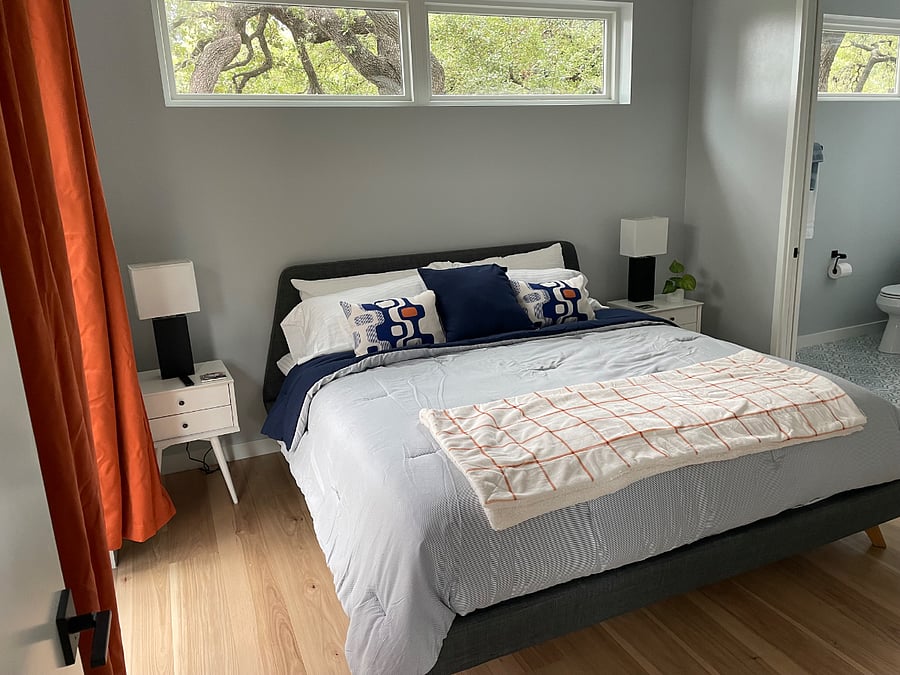 2nd Bedroom with king size bed, bathroom, walk in closet and SmartTV. The room accesses the 2nd floor balcony.