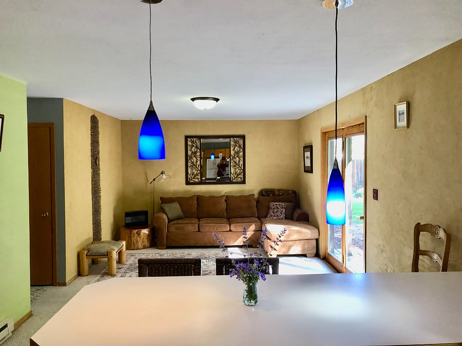 1st Living room. Beautiful clay paint walls, cozy seating. Opens onto the back yard and deck.