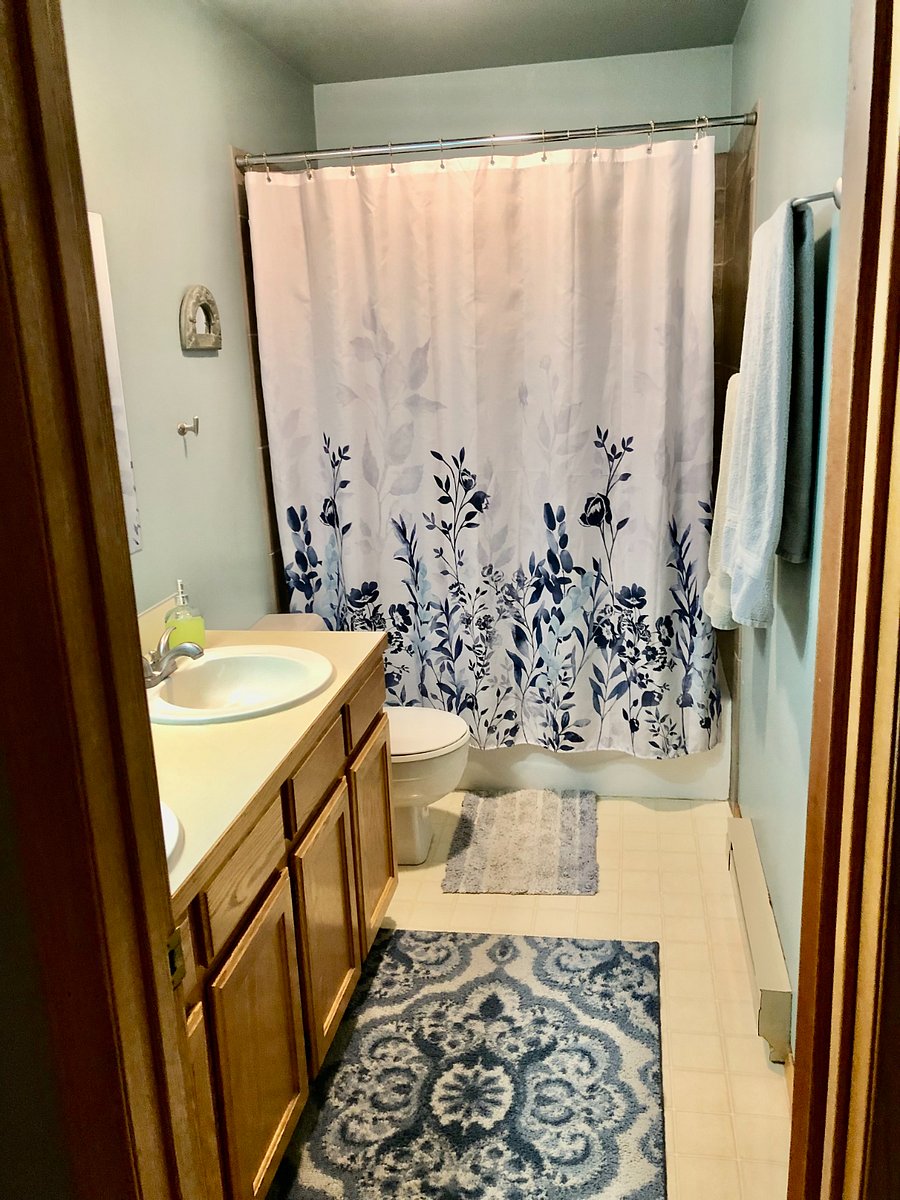 Bathroom, stone tile shower and tub, 2 sinks and lots of shelf space.