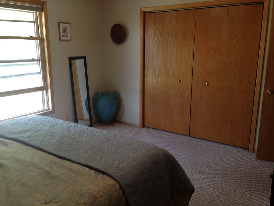 Master bedroom, organic California King mattress and black out curtains, two closets and a dresser.
