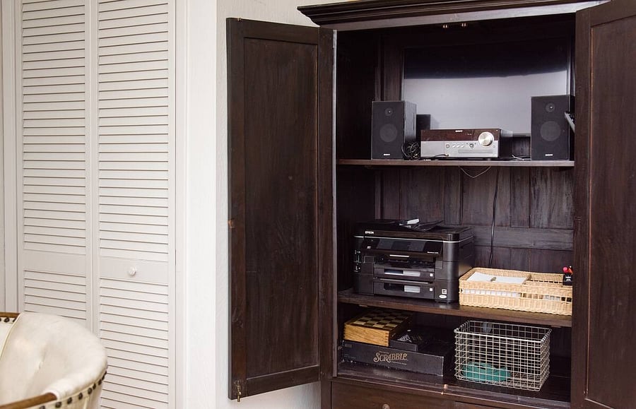 Cabinet with office supplies. Speakers. Yoga props.