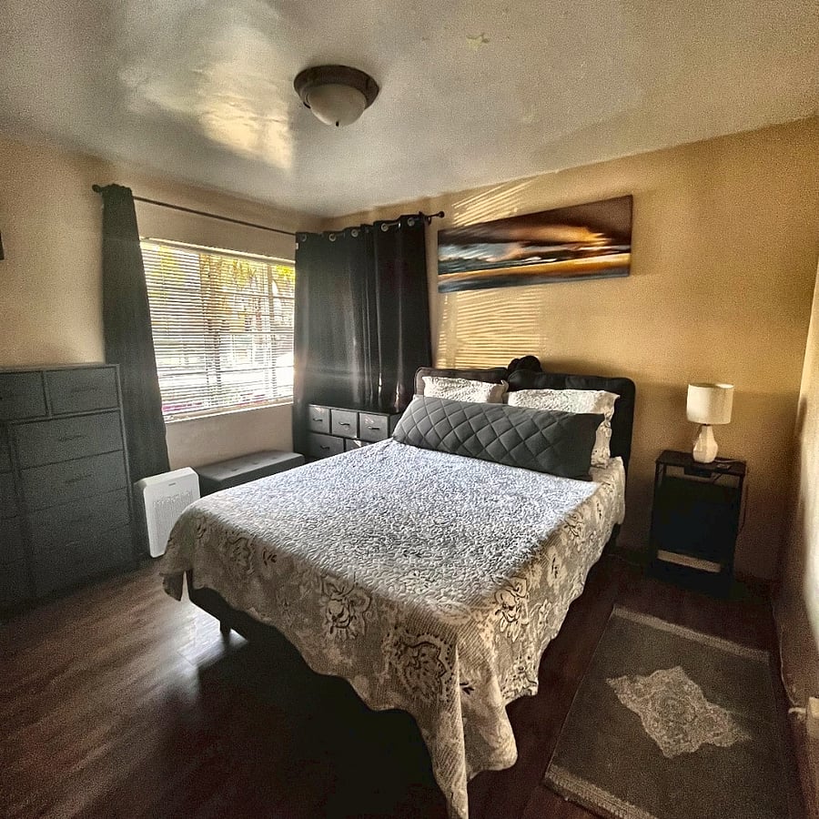Restful Sleep (Blackout Curtains): A serene bedroom retreat with a plush Queen bed and premium blackout curtainsperfect for daytime sleepers and night-shifters.
