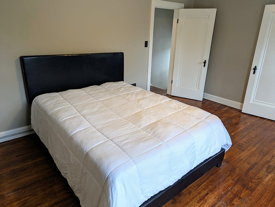 Front bedroom with queen bed. Closet to the right