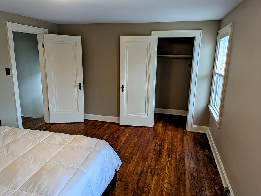 Front bedroom with queen bed and closet