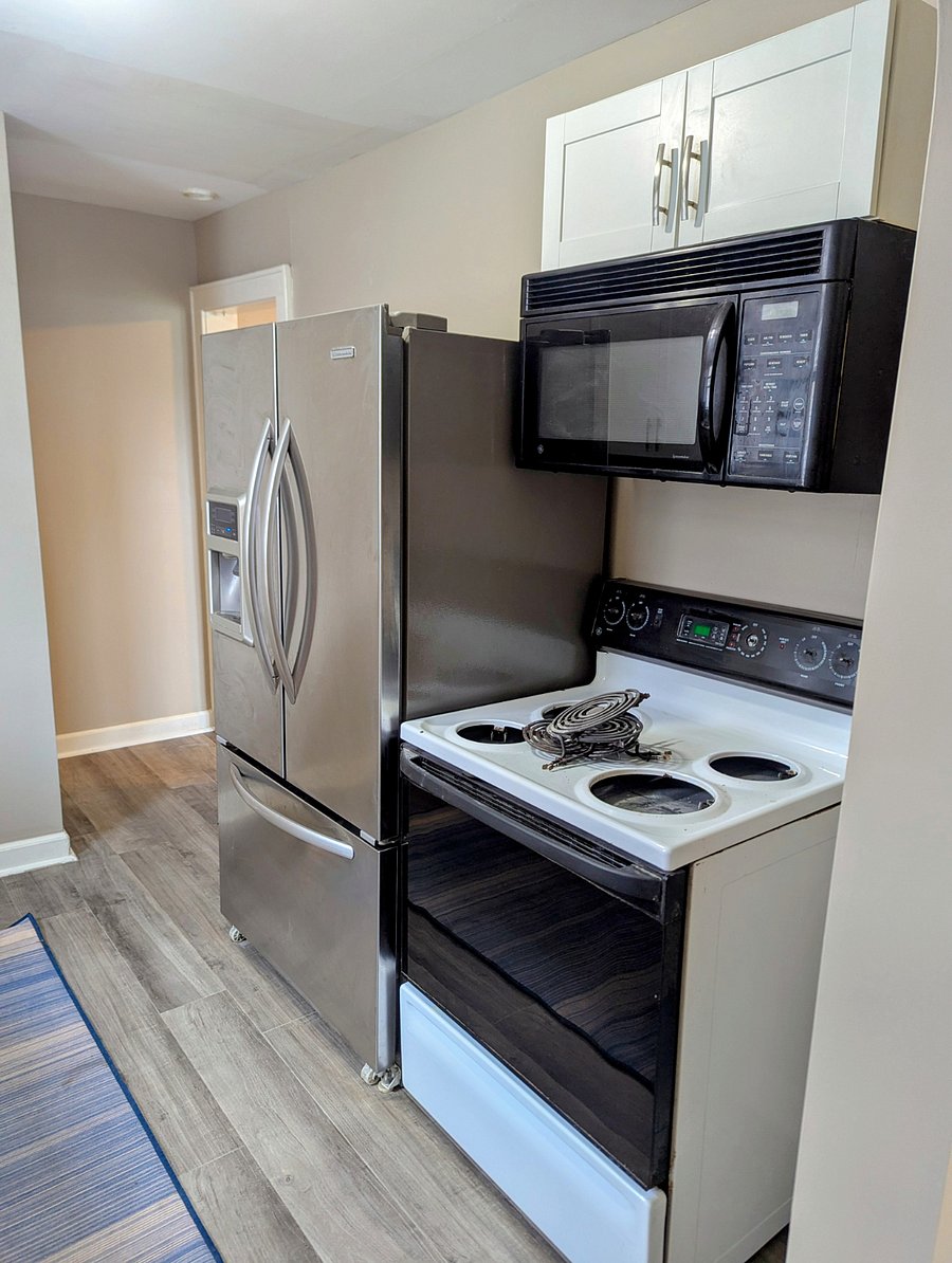 French door refrigerator with ice and water dispenser. Electric range and microwave