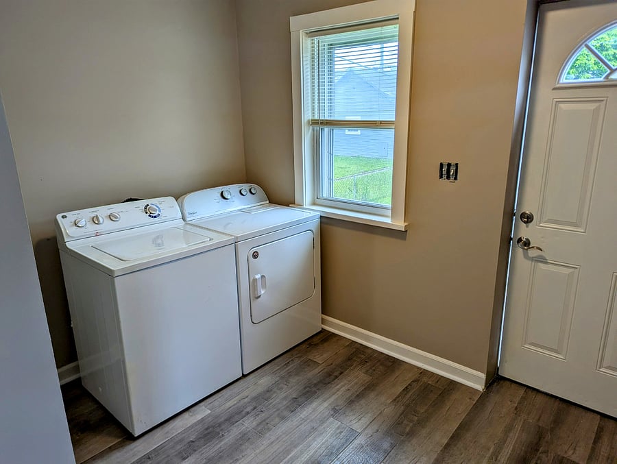 Washer and dryer on main level with rear exit to fenced in backyard