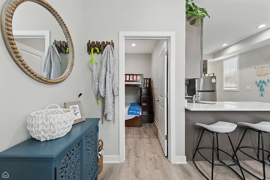 This cozy entryway flows into bedroom 2 with a double-double bunk bed. Ideal for family living or an extra space for guests.