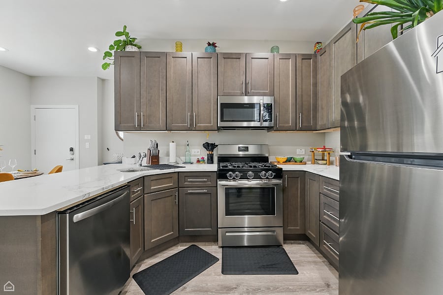 A modern kitchen designed for everyday ease and elevated experiences. Featuring a full suite of stainless steel appliances and generous cabinet space.