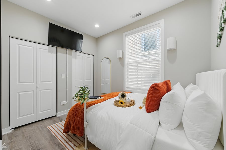 Soft sunlight and vibrant earth tones make this master bedroom the perfect place to recharge. From the plush pillows to the tray of thoughtful touches, every detail is designed to help you settle in, unwind, and feel right at home.