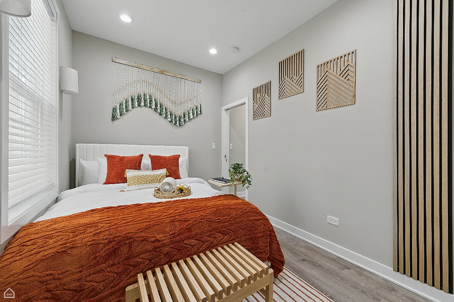 A cozy bedroom filled with warm light and colorful charm. Layered textures, soft bedding, and bold details create a space that feels both vibrant and restfulthe perfect balance for any stay.