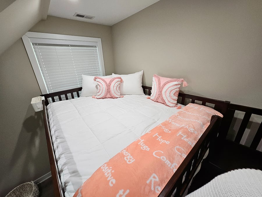 The upper bunk offers a snug and quite corner with plush pillows and inspirational throw blanket.