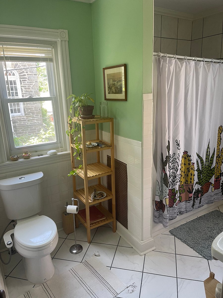 Bathroom with small tub, closet, small sink and vanity