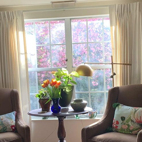 The exterior property is nicely landscaped with many mature trees (this is a springtime view as seen through the east-facing Living Room window).