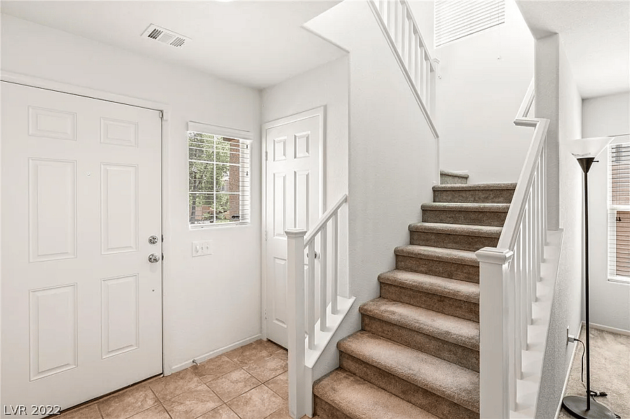 Front door and stairway that leads to the guest room.