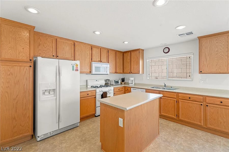 Wide shot of the kitchen, fully stocked with cooking supplies (ingredients and pots/pans).