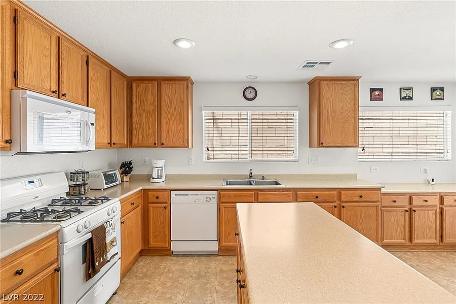 Wide shot of the kitchen, fully stocked with cooking supplies (ingredients and pots/pans).