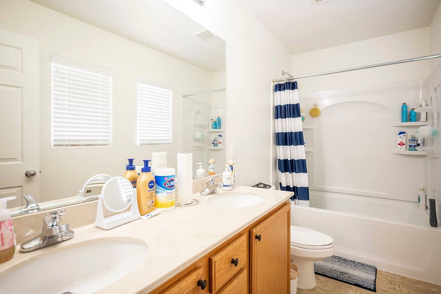 The dual-vanity guest bathroom, with complimentary shampoo, conditioner, and lotion.