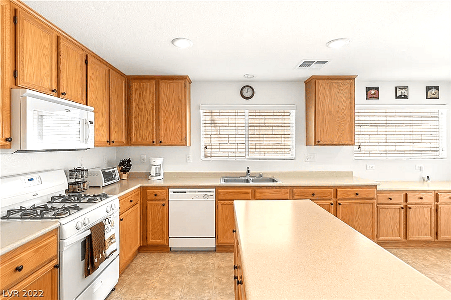 Wide shot of the kitchen, fully stocked with cooking supplies (ingredients and pots/pans).