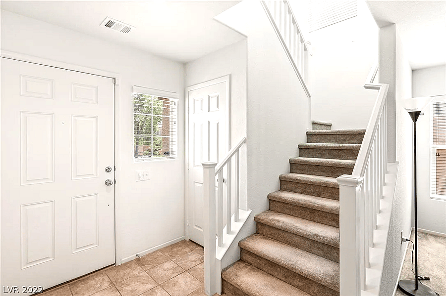 Front door and stairway that leads to the guest room.