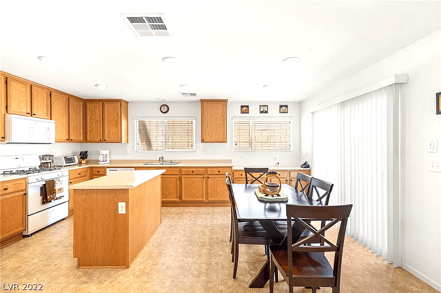 Wide shot of the kitchen, fully stocked with cooking supplies (ingredients and pots/pans).
