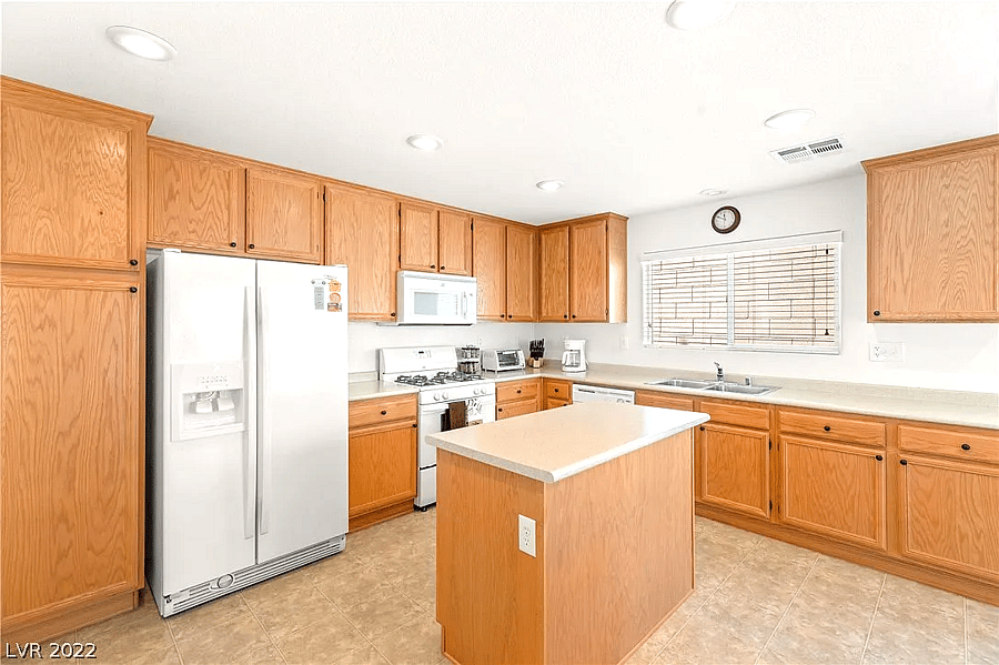 Wide shot of the kitchen, fully stocked with cooking supplies (ingredients and pots/pans).