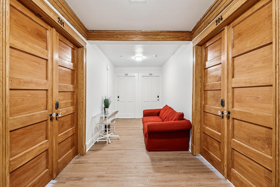 The shared foyer with entrances to each of the 4 residential units in the complex. 