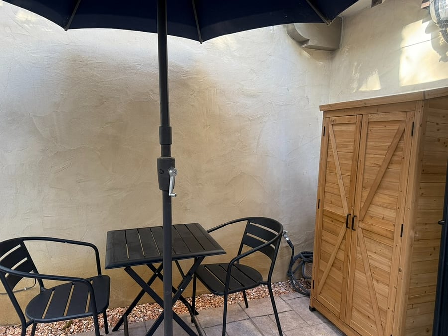 Private patio with cedar storage unit.
