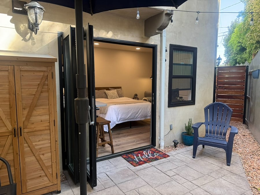 Indoor- outdoor living on your private patio with cedar storage shed.