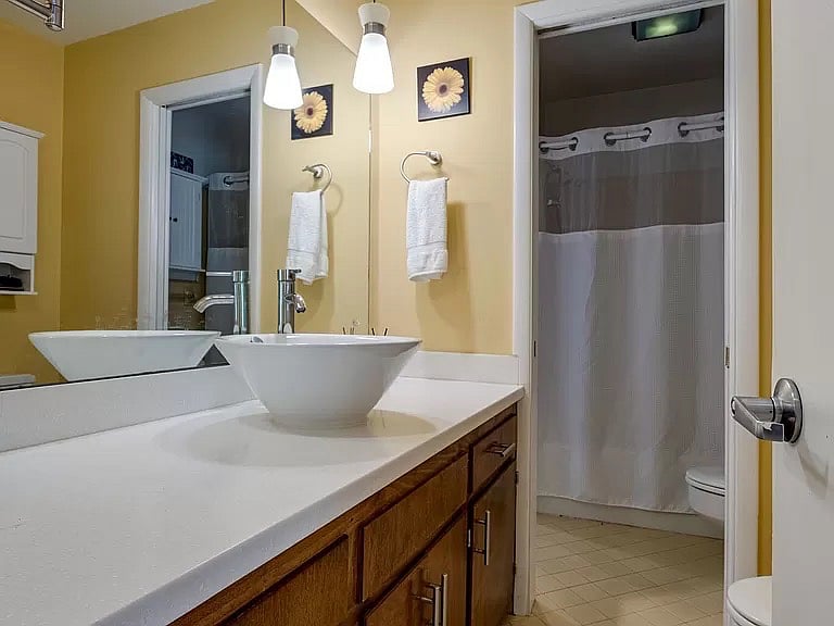 This is the hallway-accessible 1/2 bath with vanity. This has been the "hers" bathroom for as long as we've lived here.