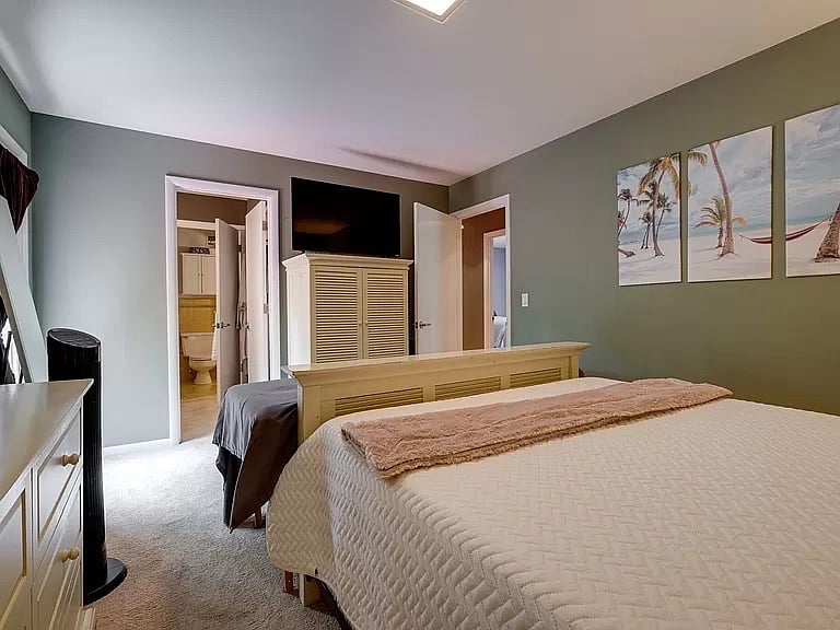 A view from the headboard area of the master bedroom. The massage table at the foot of the bed is not included.