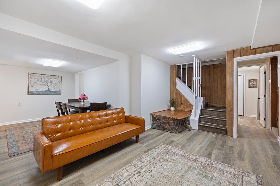  Spacious, private lower-level living and dining space with stylish touches and natural wood details.