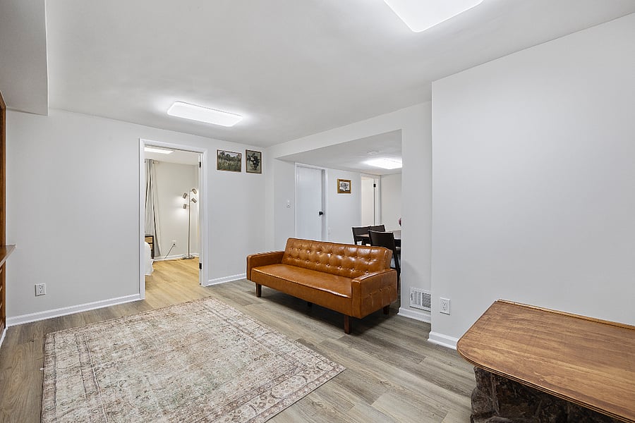  Spacious, private lower-level living and dining space with stylish touches and natural wood details.