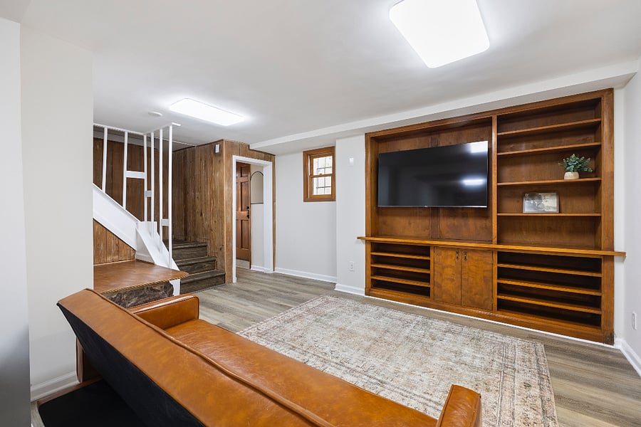  Relax after work in your cozy living room with built-in shelving and a mounted flat-screen TV.