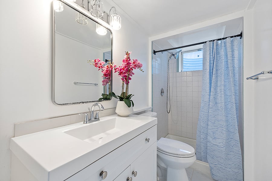  Bright, updated bathroom with full-size shower and modern vanity.