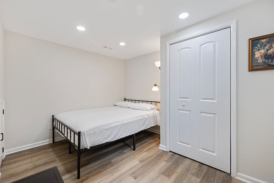  Second bedroom with soft lighting, closet storage, and a quiet atmosphere for peaceful sleep.