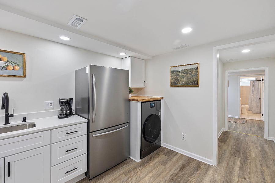 (Kitchen close-up with coffee station and laundry):
 Start your day with coffee and convenience  induction stove, deep sink, and modern appliances included.

