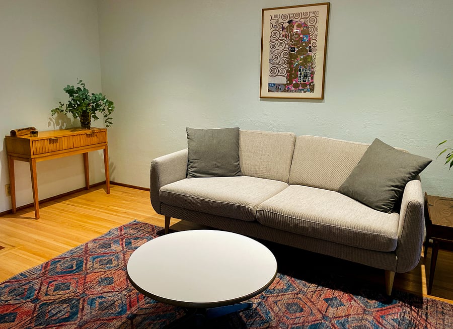 Close-up shot of living room couch and coffee table.