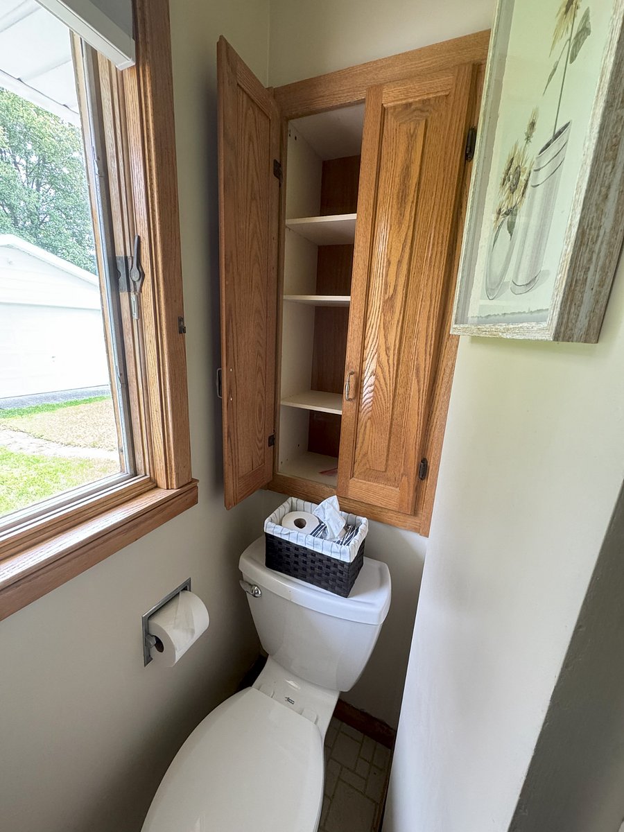 Cupboard over toilet empty for additional storage of personal items