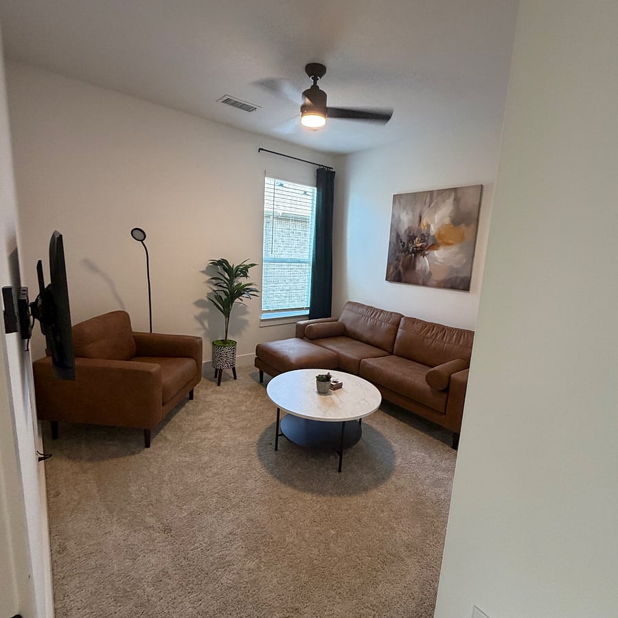 Private living/office space with high ceiling and 40-inch wall-mounted flat screen TV with Roku streaming apps