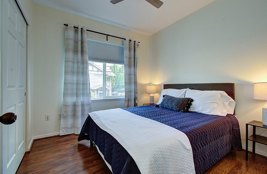 Second bedroom with queen bed and attached closet.