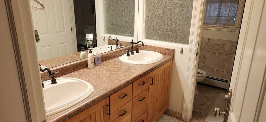 Double sinks and drawer banks in the bathroom helps to make this temporary home an easy option for a room mate or family. This portion of the bathroom has a door separating the toilet and shower for multi-user functionality.