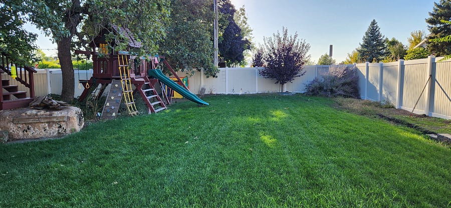 Very spacious backyard has a lovely lawn for outdoor relaxation, play, or dining. Includes playground equipment for use if desirable. 