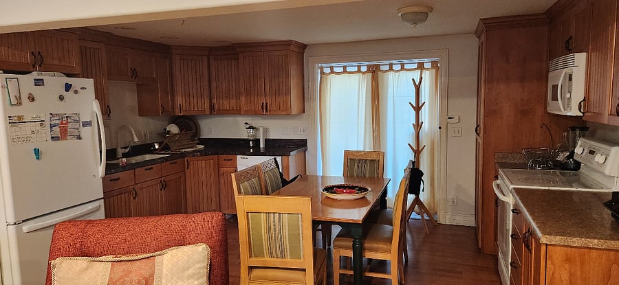 Kitchen is fully furnished with table that seats 6, microwave, full size refrigerator, stove top, and oven. Includes cookware, eating utensils, dinner and dessert plates, bowls, glassware, cooking pans, skillets, cookie and muffin tins, cutting boards, and knifes. Some spices and oils.