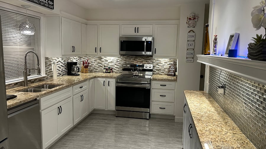 kitchen stocked with appliances, plates/bowls, utensils, pots/pans, cookware