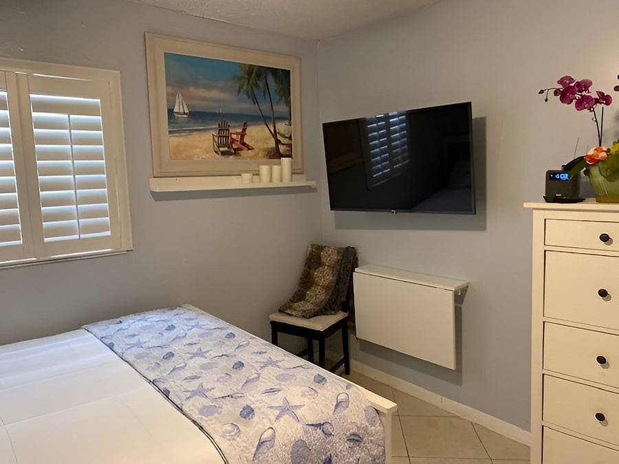 2nd bedroom: LG 43" 4K smart TV, w/ full cable package, dresser to the right.