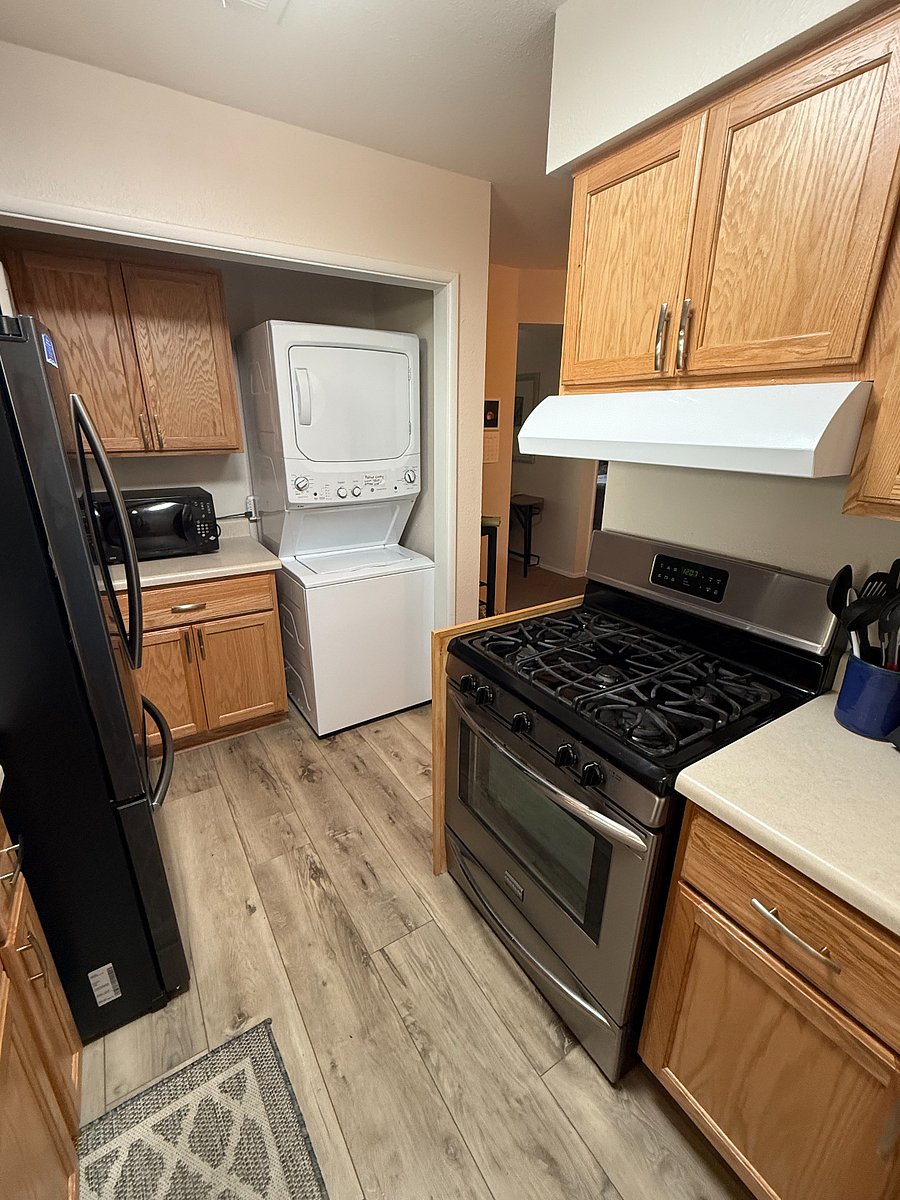 Kitchen with gas stove and view of laundry.