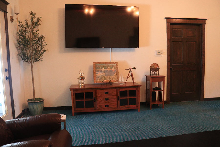 Large living room with wall mounted smart tv