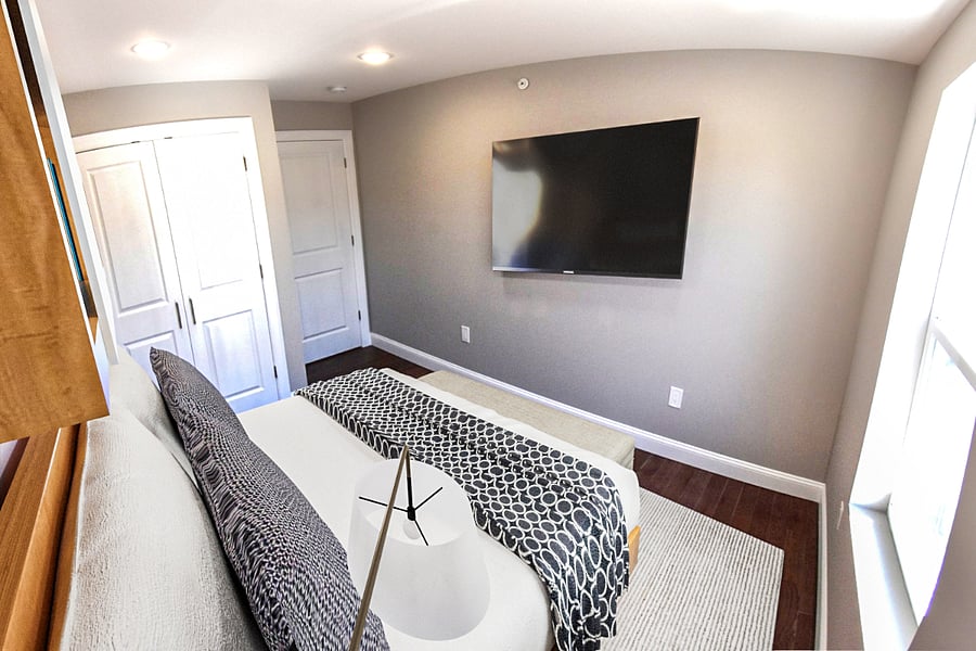 Bedroom #3 with queen size bed, 4K smart TV, closet organizer, night stand and wall bookshelf.