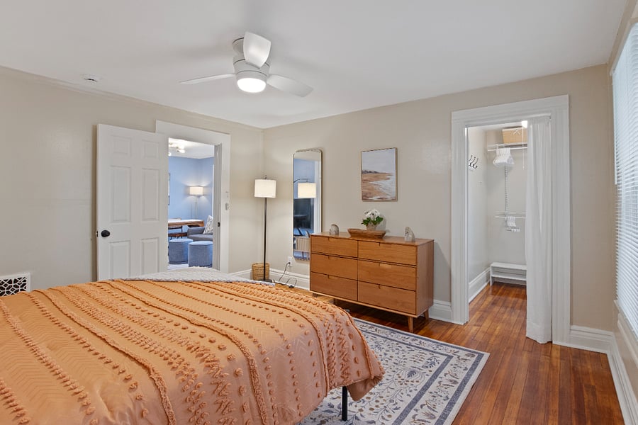 Master bedroom looking into living room with view of walk-in closet.